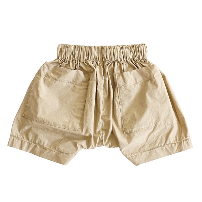 Pull on harem shorts in yellow gold with large patch pockets from the back.