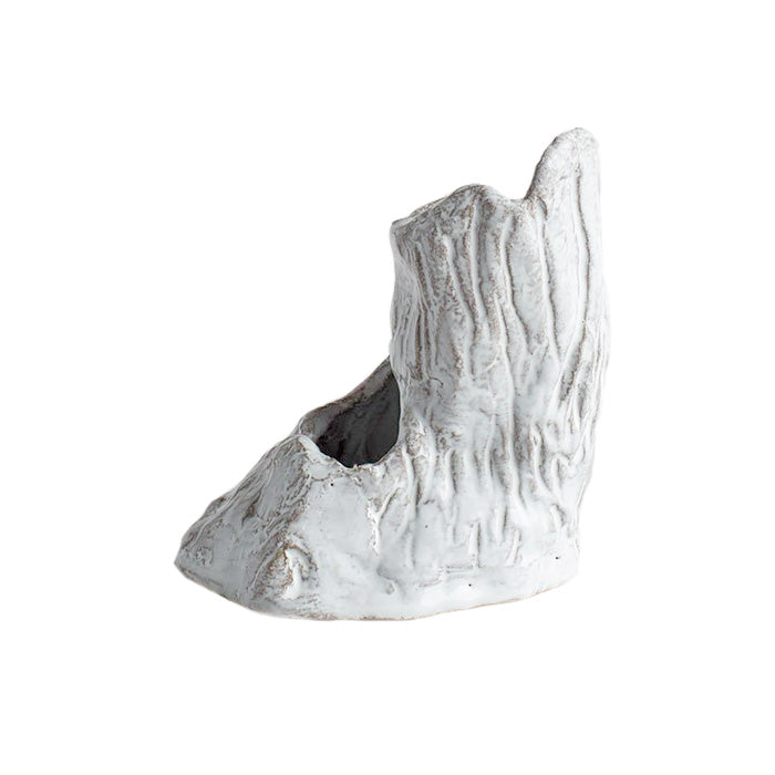 Tree trunk shaped vase with two openings in a white glaze from the side.