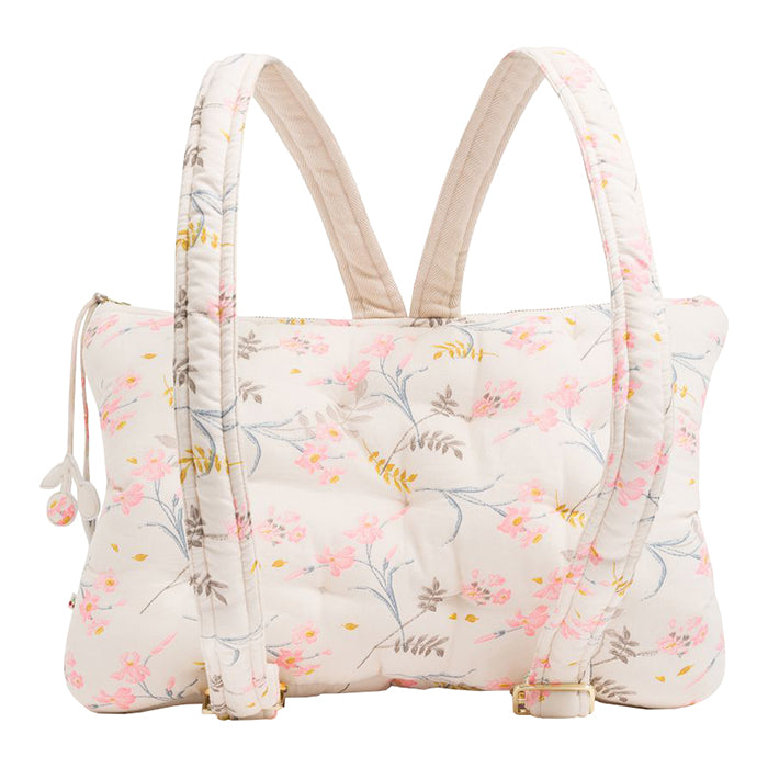 Pillow shaped backpack in cream with an all over pink and brown floral print from the back.