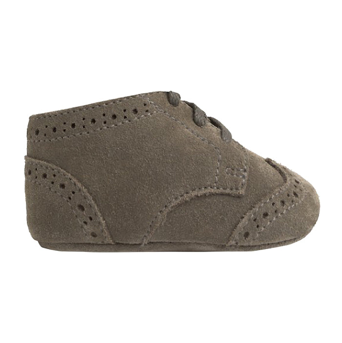 Grey green suede shoes with oxford style details from the side.