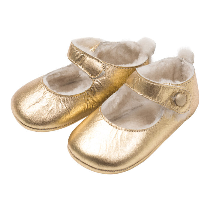 Shiny gold mary jane shoes with a cream fur lining.