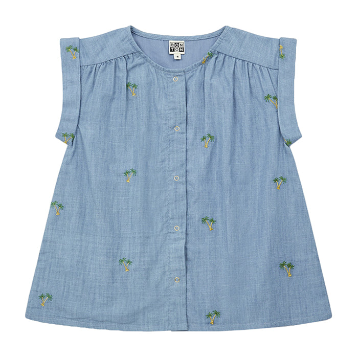 Blue chambray sleeveless blouse with all over embroidered palm trees.