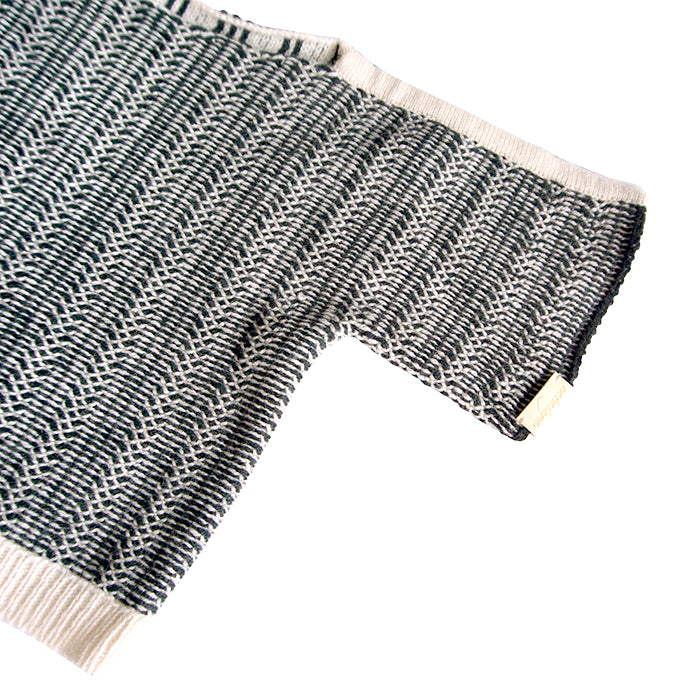 Close up of the black and cream knit design and cream ribbed knit trim.