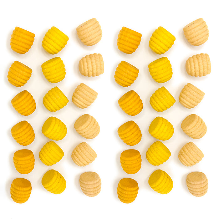 Wooden mini honeycomb shaped pieces in various shades of yellow.