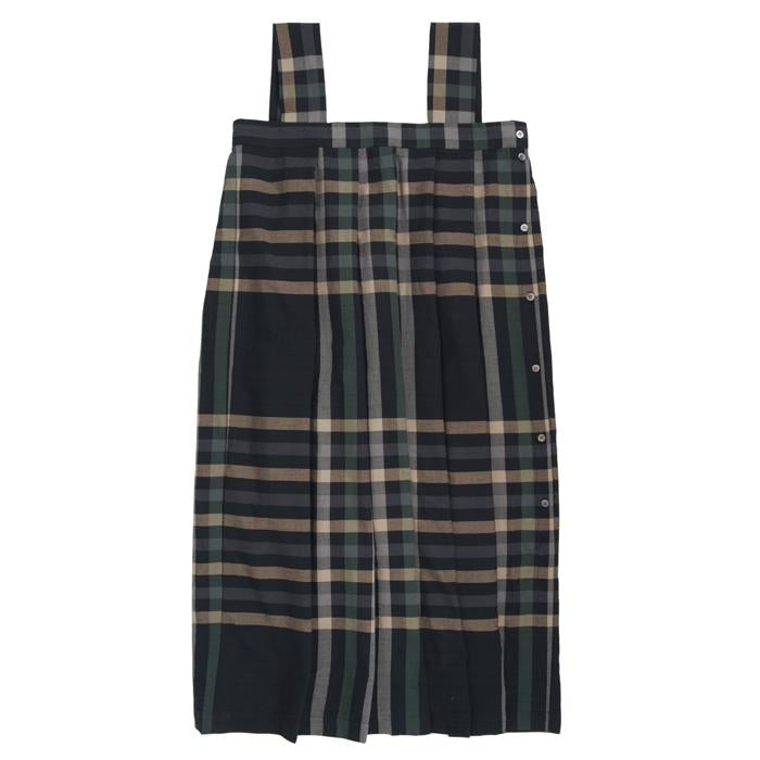 Sleeveless pleated dress with button closure down the side in black with a large beige and green plaid pattern.