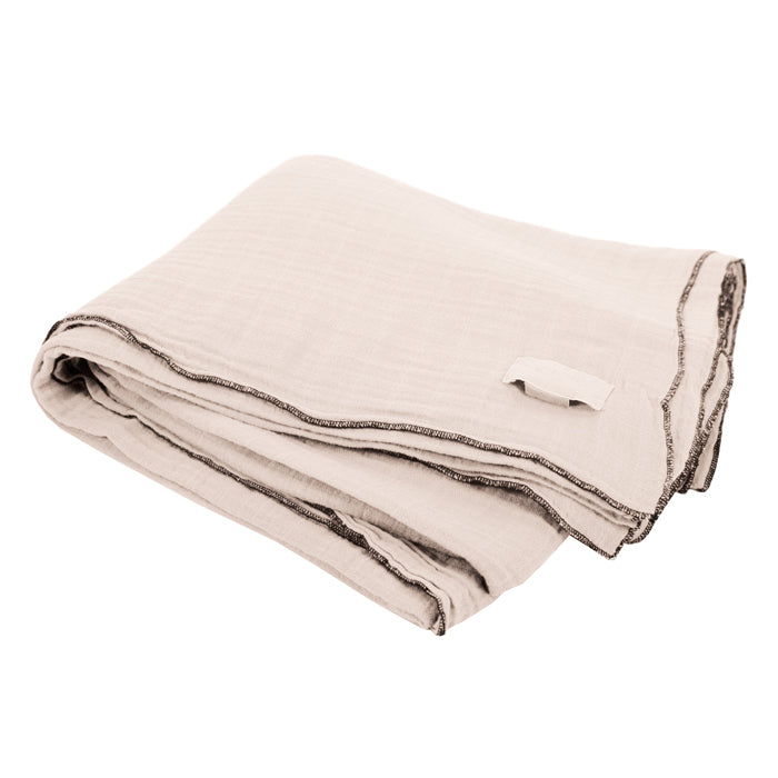 Cream folded cotton gauze tablecloth with black sewn edges.