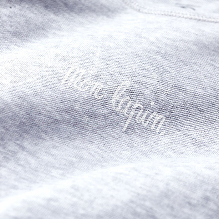 Close up of the grey jersey fabric and "Mon lapin" print on the chest.