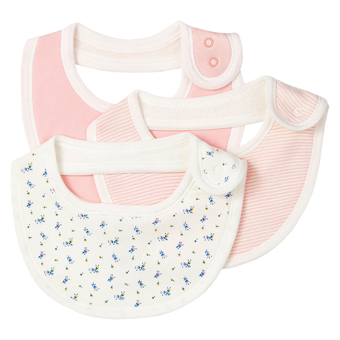 Three jersey bibs with snap closure at the back in pink, pink stripes, and a cream floral print.