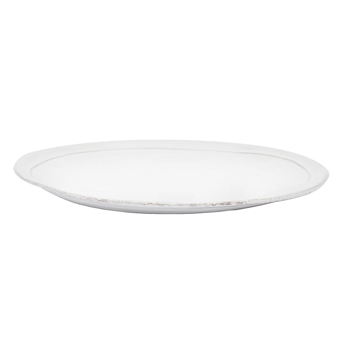 Round ceramic side plate with a milky white glaze from the side.