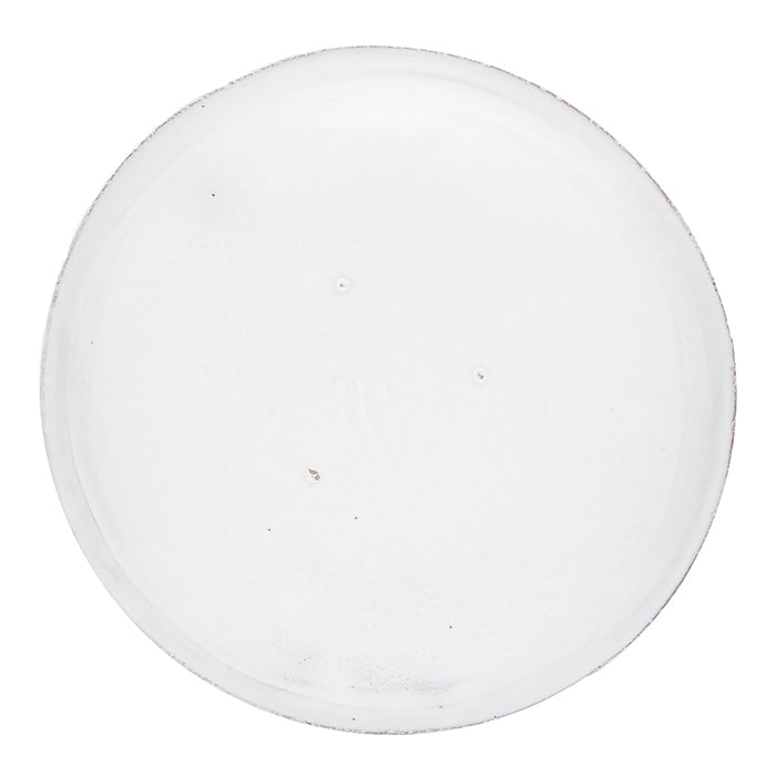 Round ceramic side plate with a milky white glaze from the back.