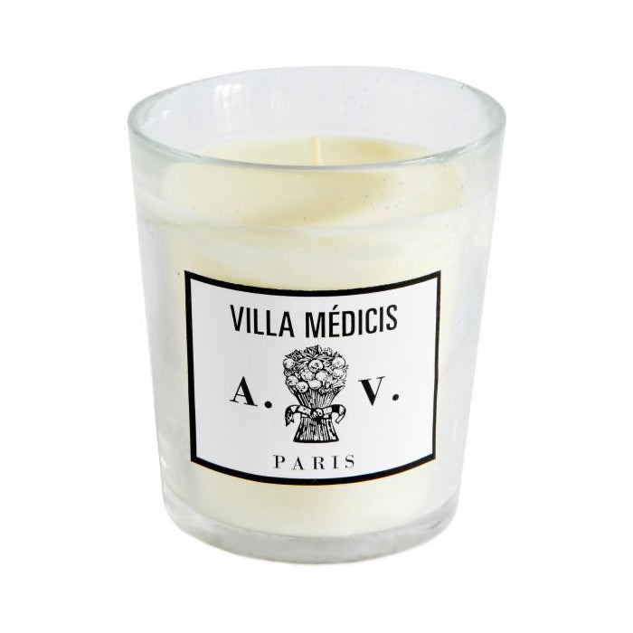 Candle in a hand-blown glass container with a vintage black and white label.