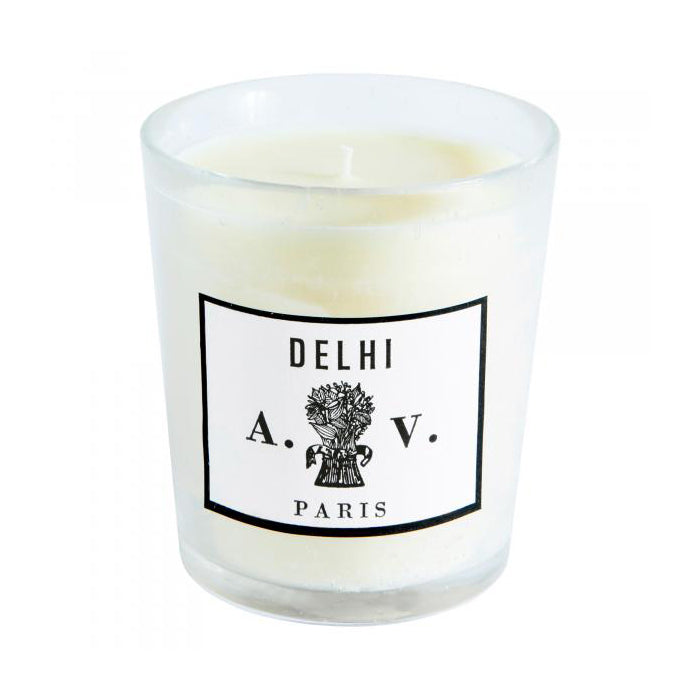 Candle in a hand-blown glass container with a vintage black and white label.