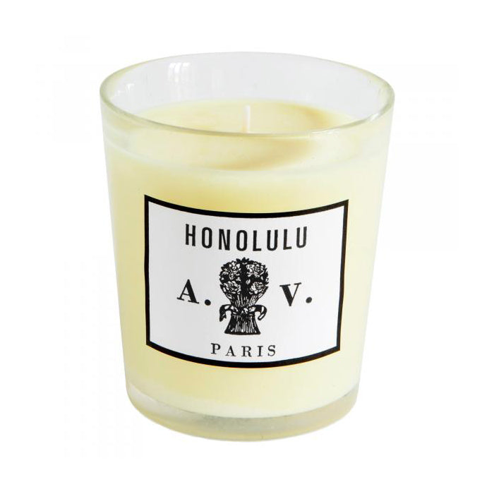 Candle in a hand-blown glass container with a vintage black and white label.