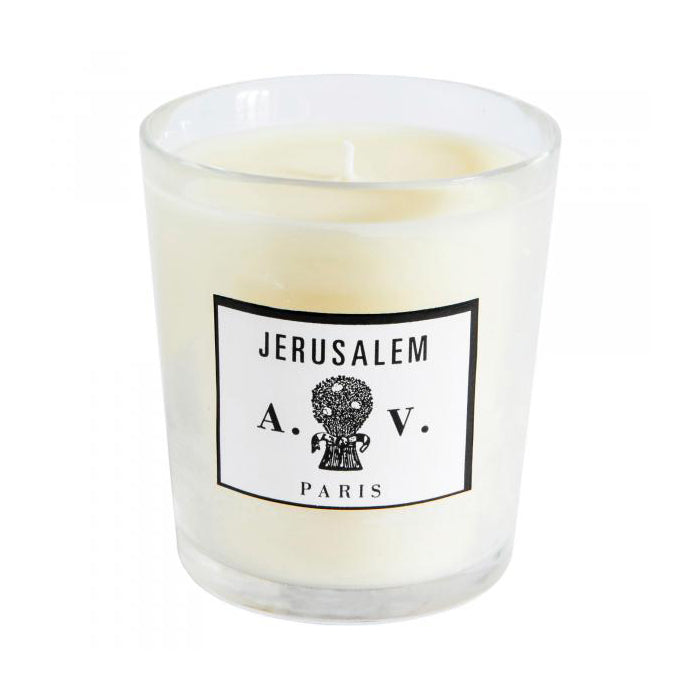 Candle in a hand-blown glass container with a vintage black and white label.