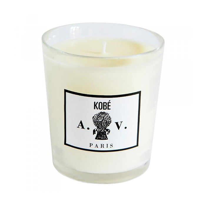 Candle in a hand-blown glass container with a vintage black and white label.