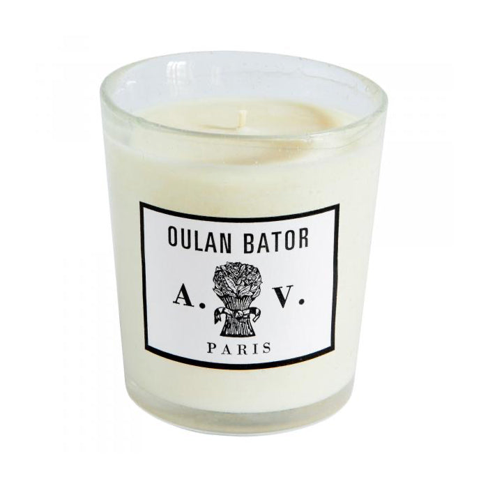 Candle in a hand-blown glass container with a vintage black and white label.