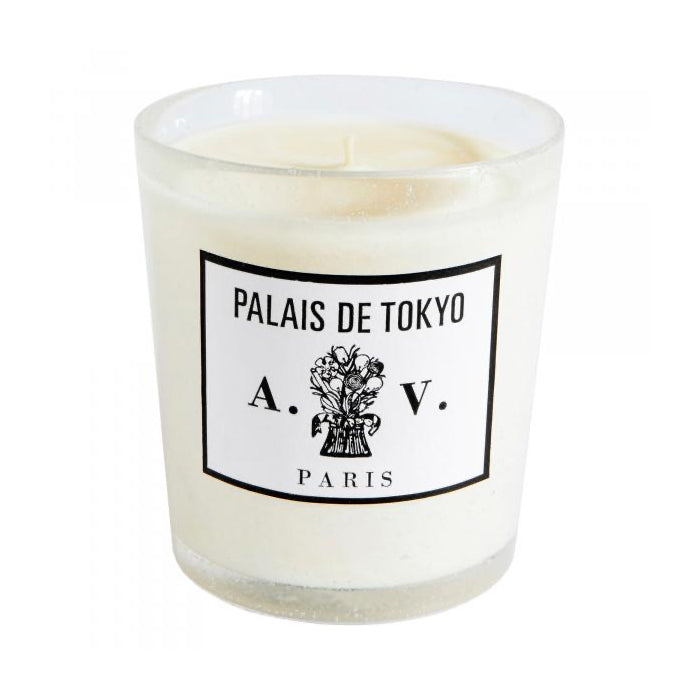 Candle in a hand-blown glass container with a vintage black and white label.