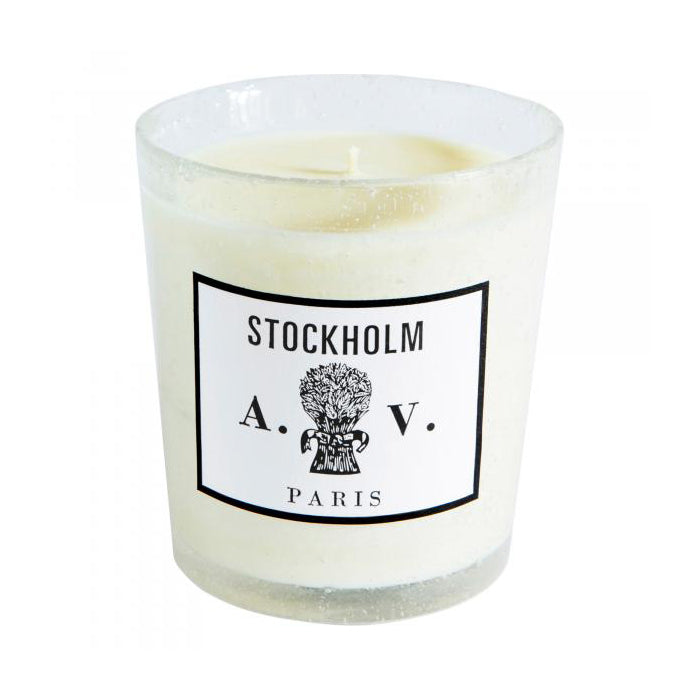 Candle in a hand-blown glass container with a vintage black and white label.