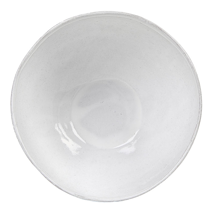 Round ceramic bowl with a milky white glaze from above.