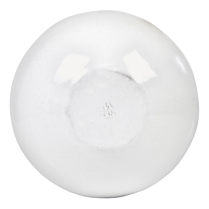 Round ceramic bowl with a milky white glaze from below.