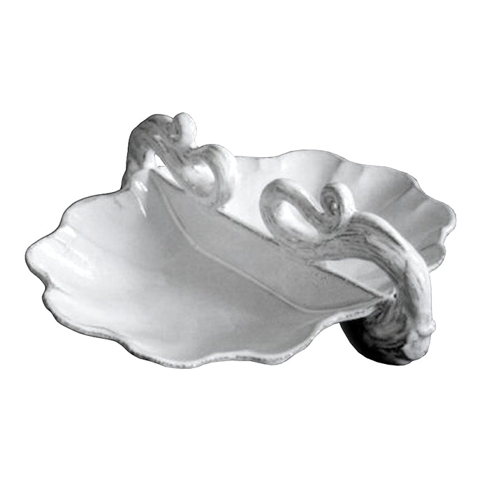 Ceramic platter with scalloped edges and swirl details in a milky white glaze.