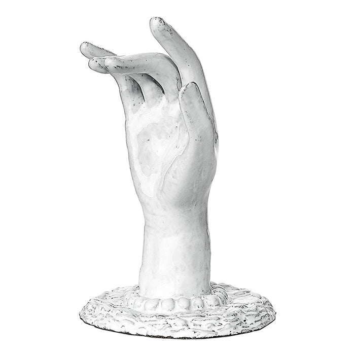 Decorative ceramic hand shaped ornament with a base in a milky white glaze.