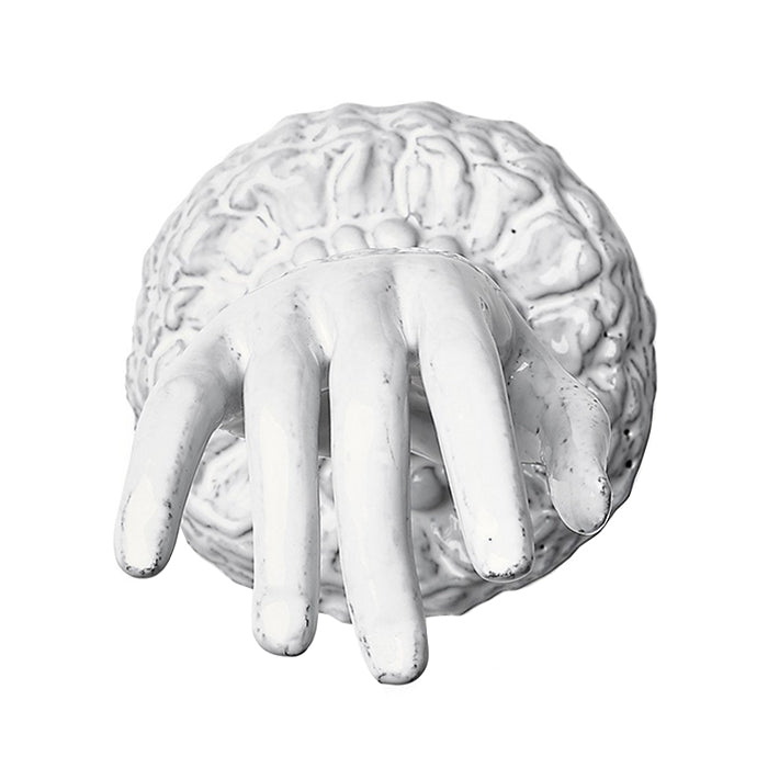 Decorative ceramic hand shaped ornament with a base in a milky white glaze from above.