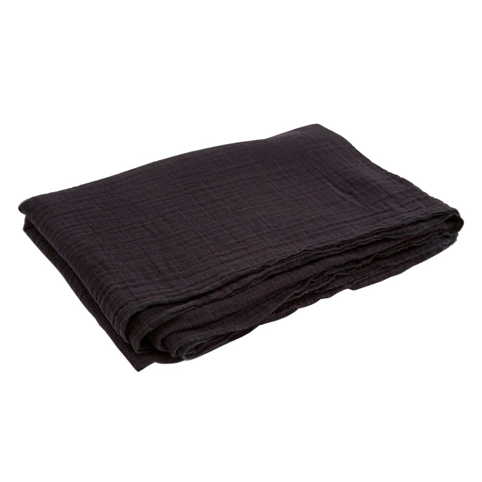 Black folded cotton gauze tablecloth.