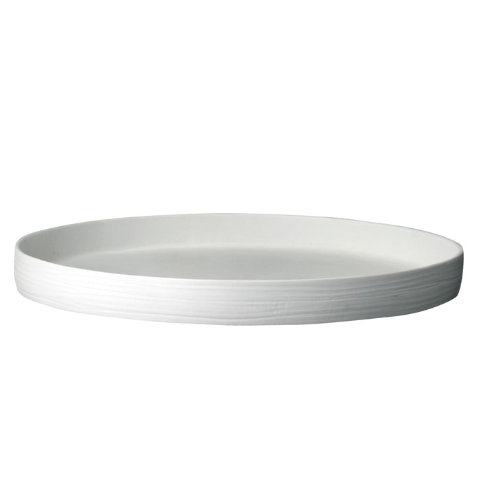 White porcelain round tray with textured edges.