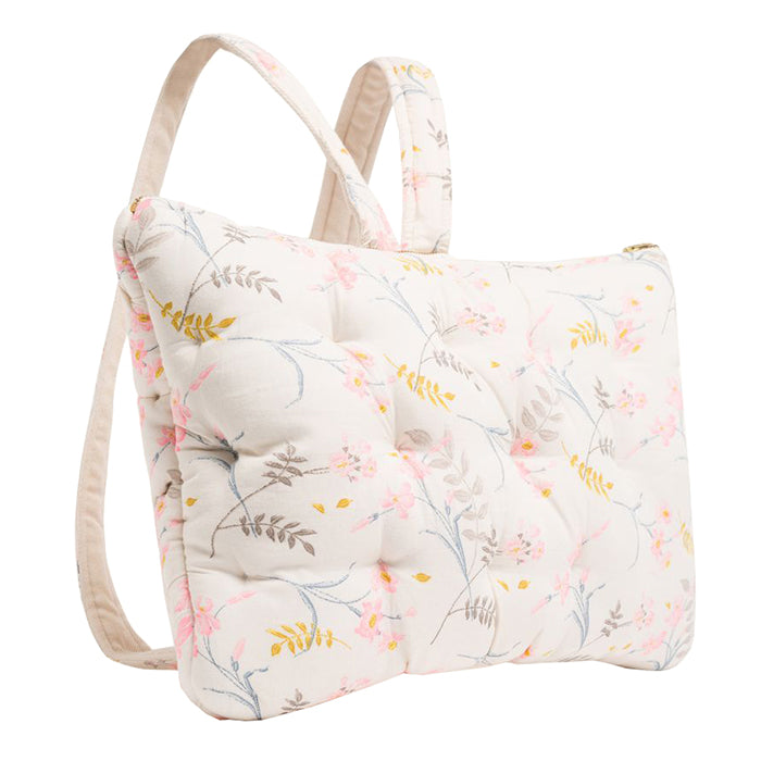 Pillow shaped backpack in cream with an all over pink and brown floral print from the side.