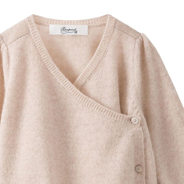 Close up of the wrap button closure down the front.