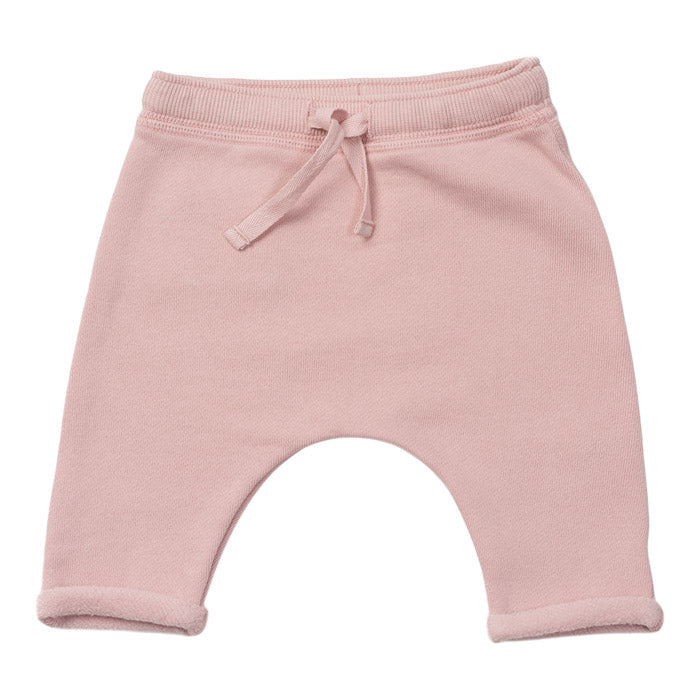 Pink harem sweatpants with a drawstring.