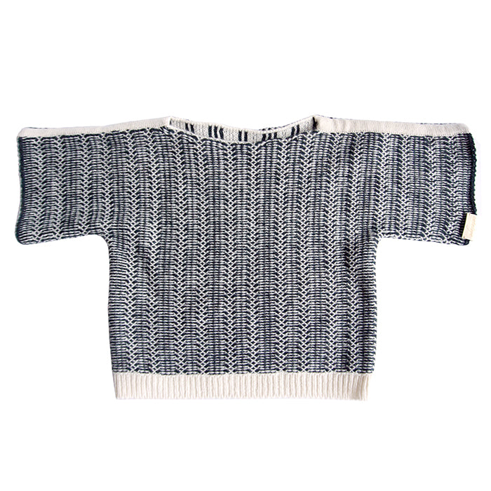 Long sleeved sweater with a cream and black knit design.