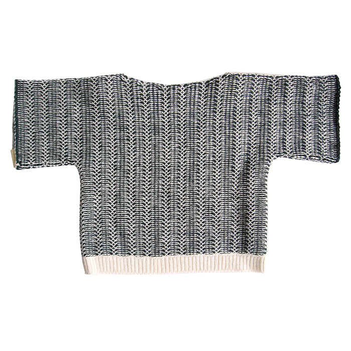 Long sleeved sweater with a cream and black knit design from the back.