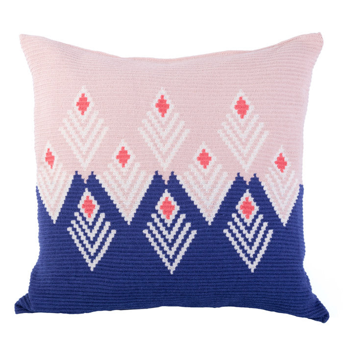 Pink and indigo blue cushion with a woven geometric diamond pattern.
