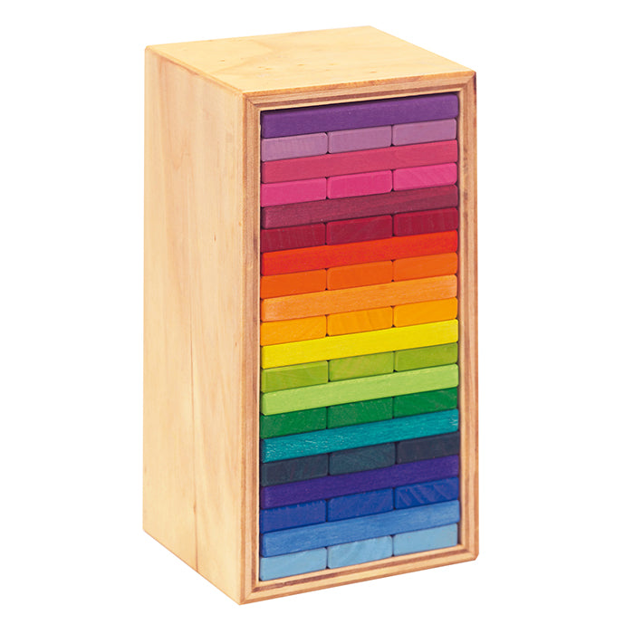 Rainbow coloured building blocks in a wooden box.