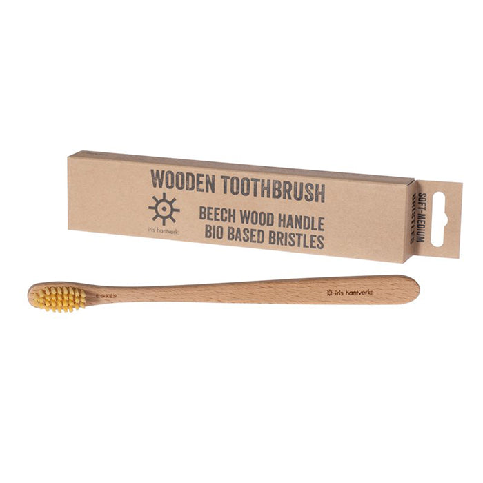 Wooden toothbrush next to its box.