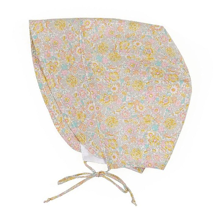 Cotton baby bonnet with ties under the chin and an all over yellow, pink, orange and blue floral print.