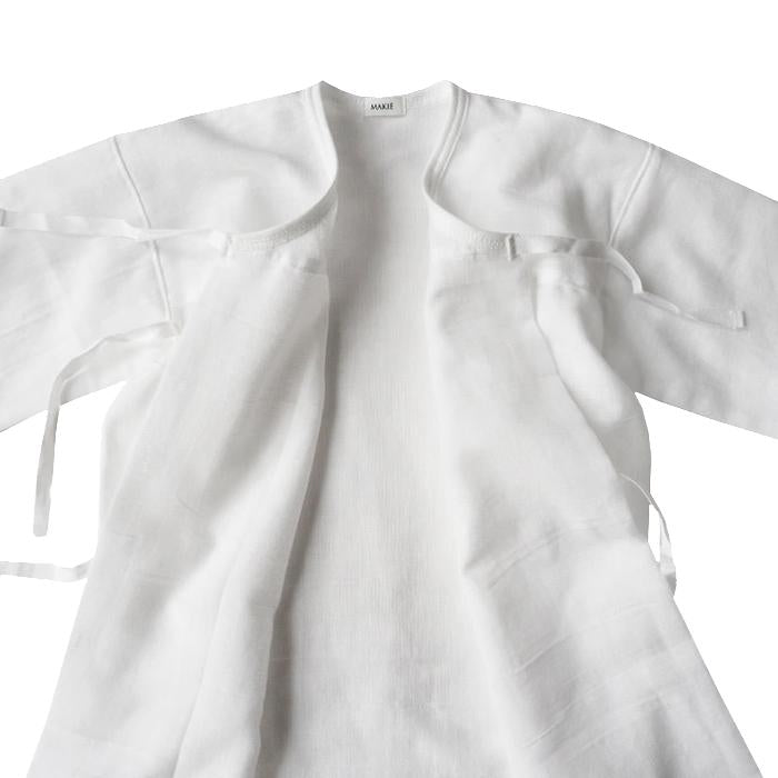 Close up of the untied white cotton gauze kimono style wrap gown.
