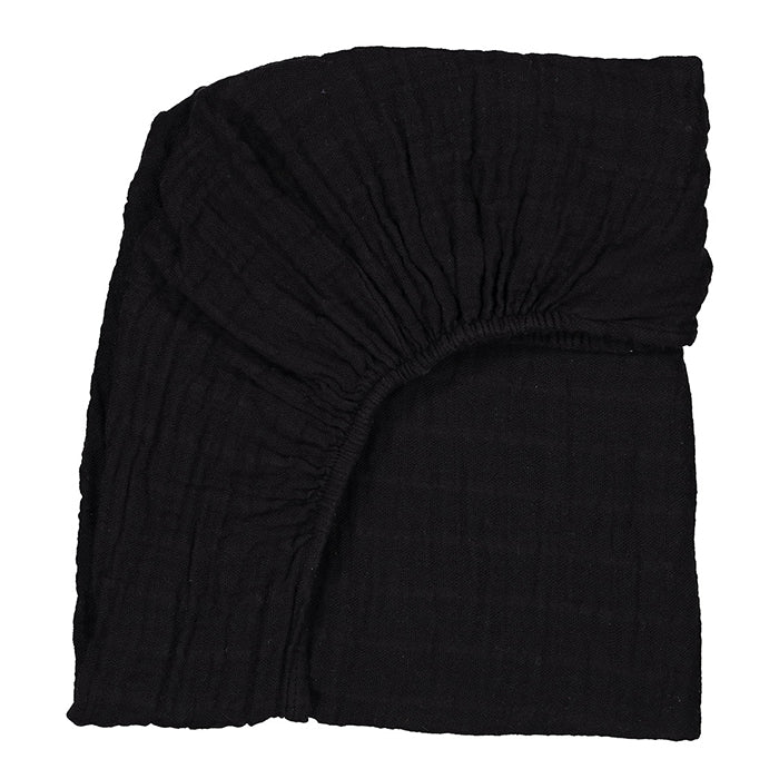 Black folded cotton gauze bed sheet.