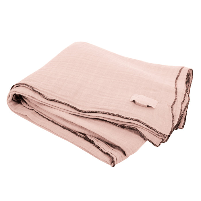 Pink folded cotton gauze curtain with black serged edges.