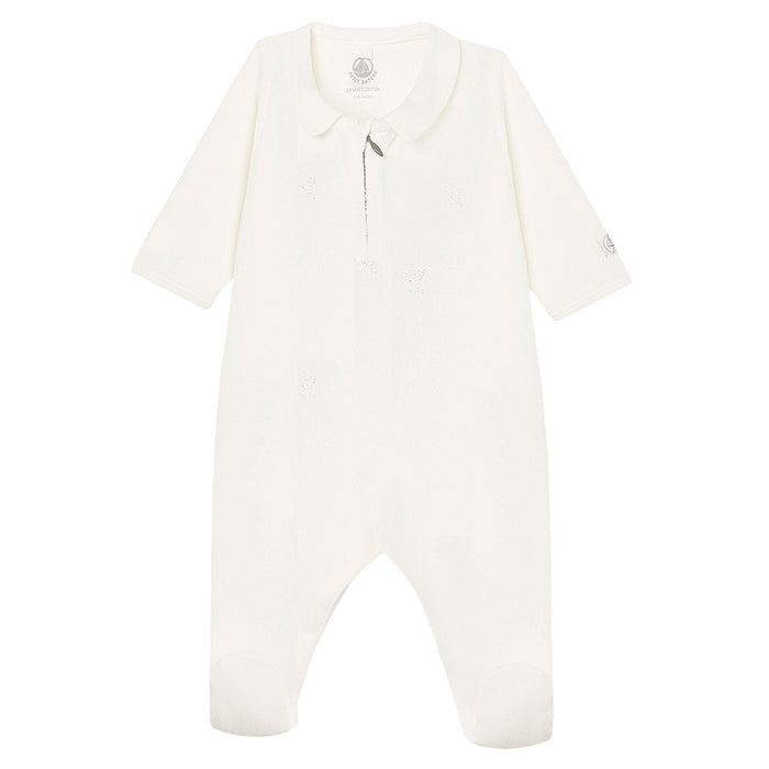 Long sleeved white pyjamas with a zip closure down the front and attached feet.