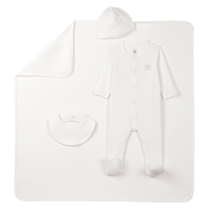 A baby gift set with cream clothing pieces laid on top of a blanket.