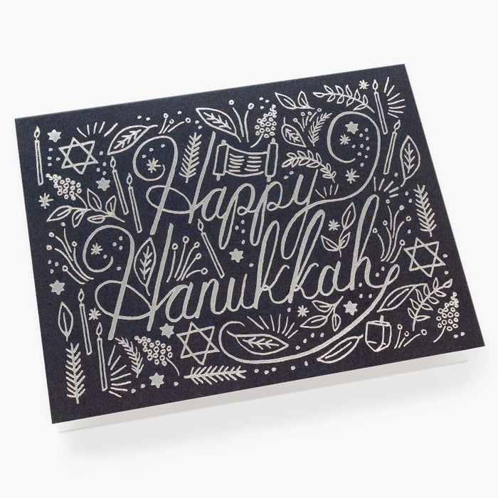 A navy Hanukkah card with a silver print.