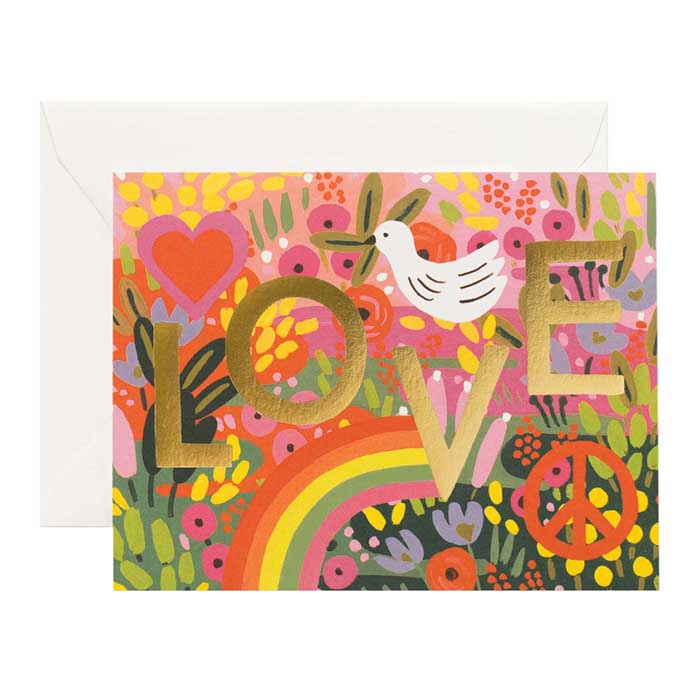 A greeting card with a bright love print over a white envelope.
