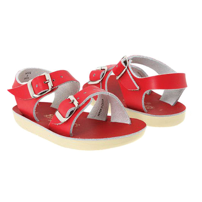Red leather sandals with a buckled strap around the ankle and across the foot.